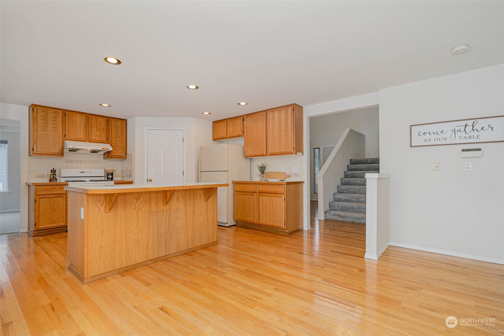 14539 144th Place Southeast Renton, WA 98059 - Photo 12 of 37 a kitchen with stainless steel appliances a stove a sink and a refrigerator