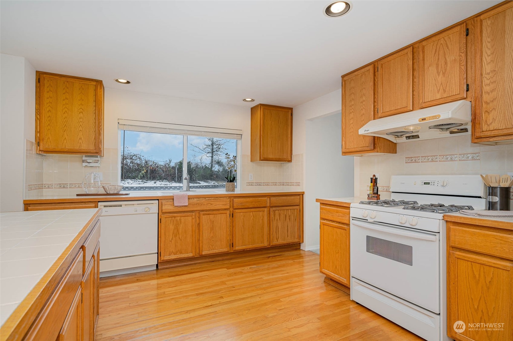 14539 144th Place Southeast Renton, WA 98059 - Photo 15 of 37 a kitchen with stainless steel appliances granite countertop a stove a sink and a refrigerator