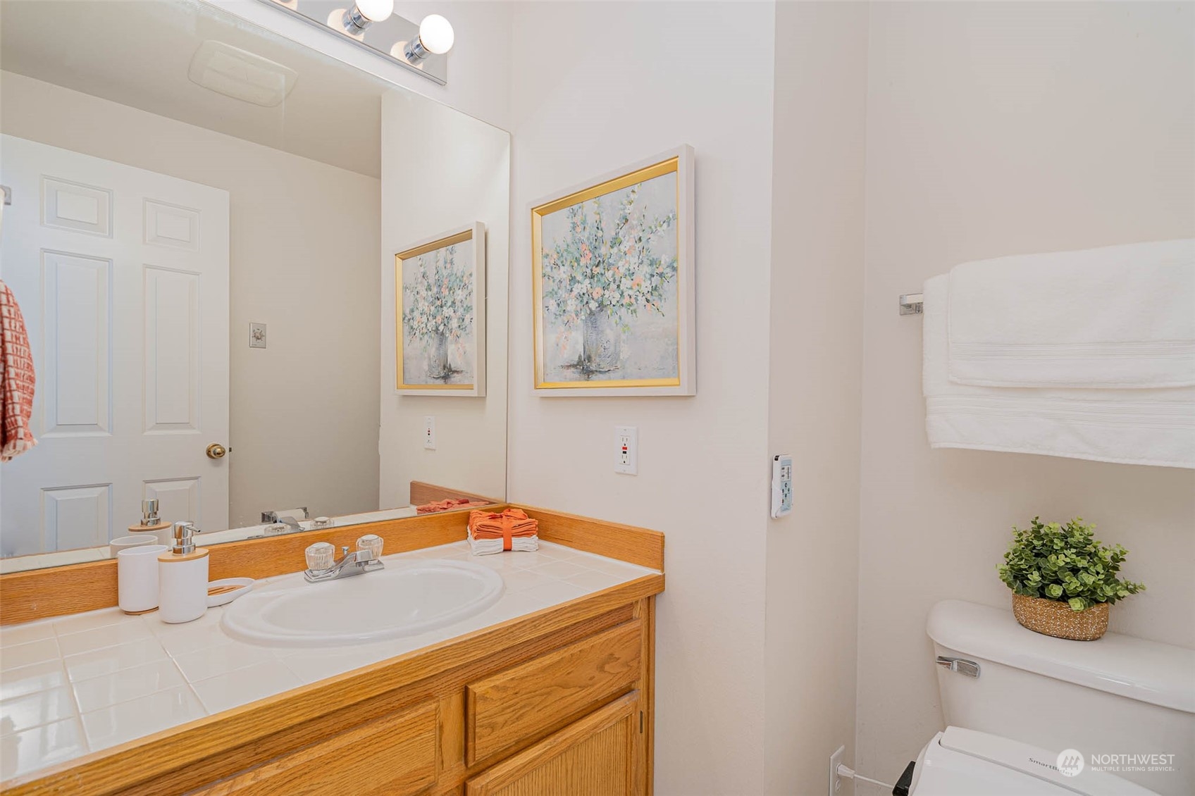 14539 144th Place Southeast Renton, WA 98059 - Photo 22 of 37 a bathroom with a granite countertop sink a toilet and a mirror