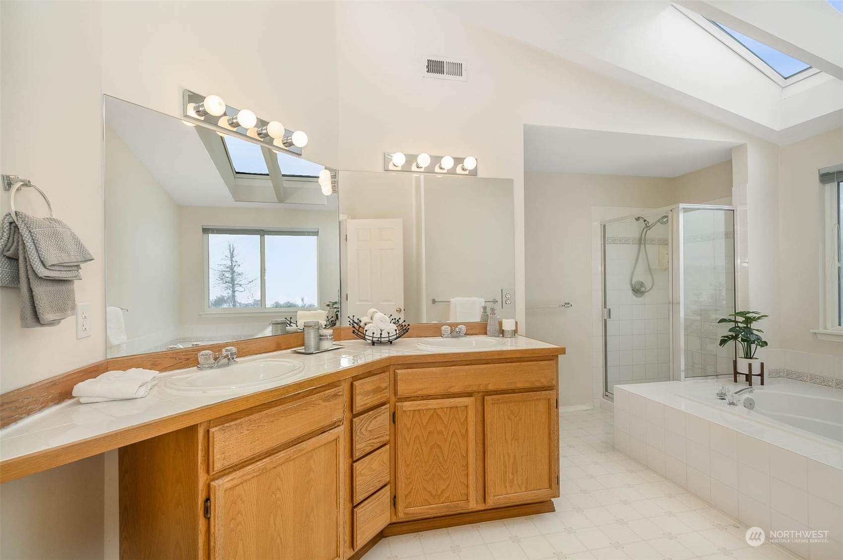 14539 144th Place Southeast Renton, WA 98059 - Photo 31 of 37 a spacious bathroom with a sink a large mirror and a bathtub