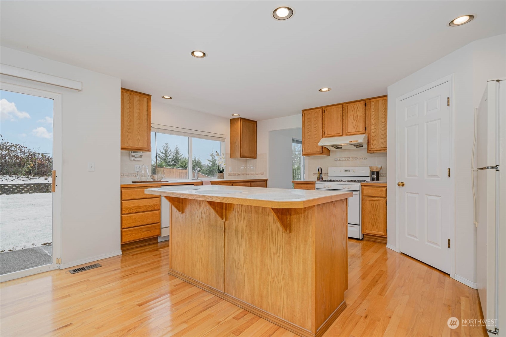 14539 144th Place Southeast Renton, WA 98059 - Photo 10 of 37 a large kitchen with stainless steel appliances granite countertop a stove a sink and a refrigerator