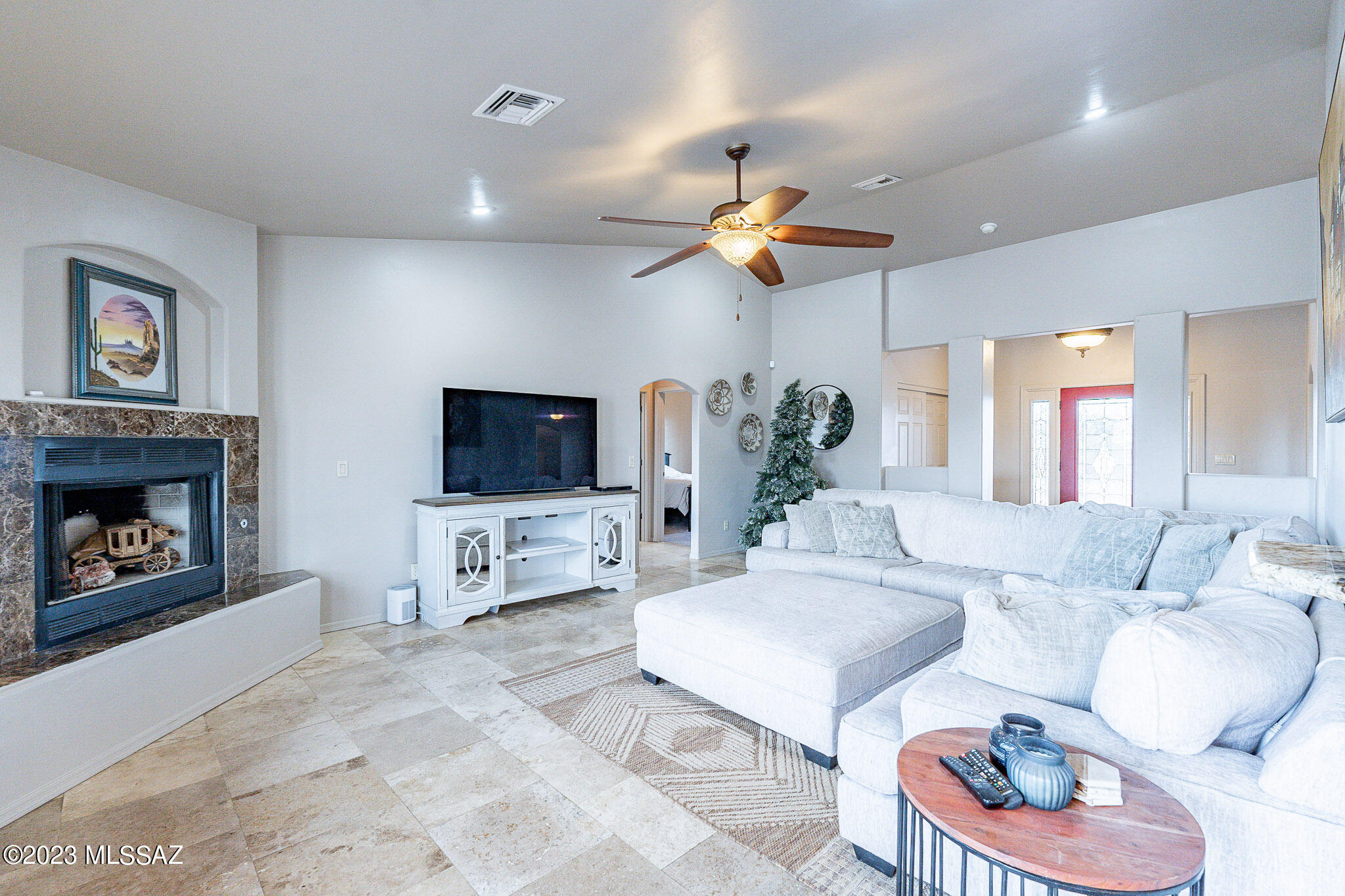1135 Via San Francisco Rio Rico, AZ 85648 - Photo 8 of 29 a living room with furniture a flat screen tv and a fireplace