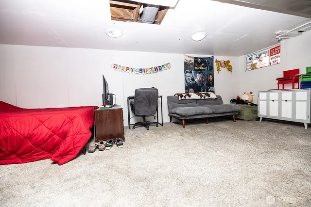 a bedroom with furniture and a window