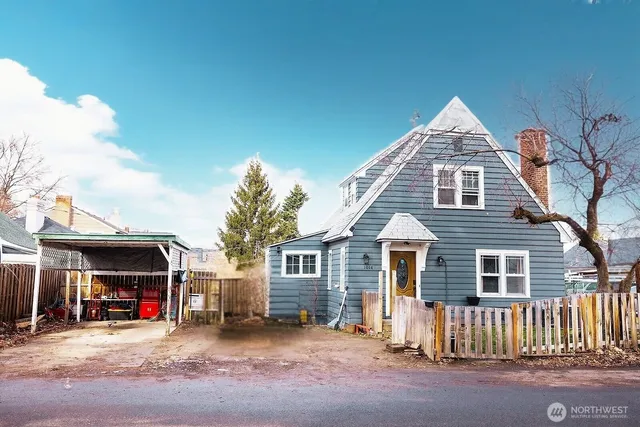 a view of a house with wooden fence