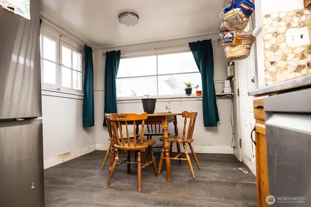 a view of a dining room with furniture a chandelier and wooden floor