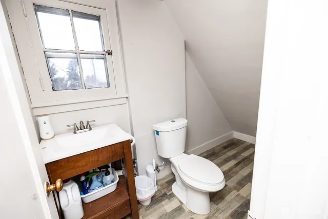 a white toilet sitting next to a bathroom sink