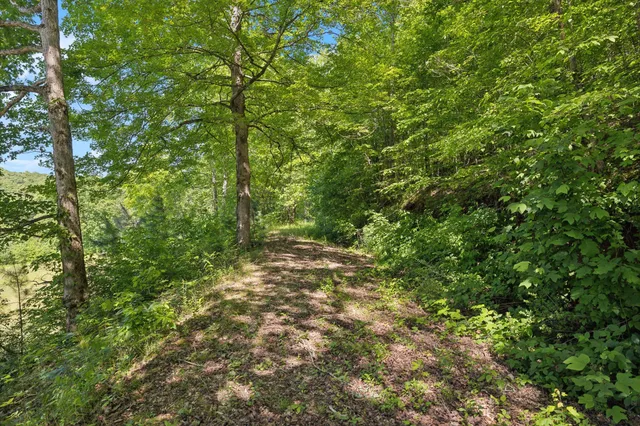 a view of a house with a wooden fence