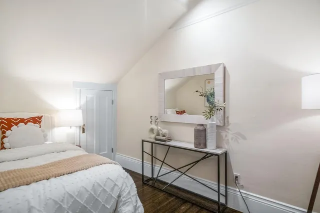 a bedroom with a bed table and window