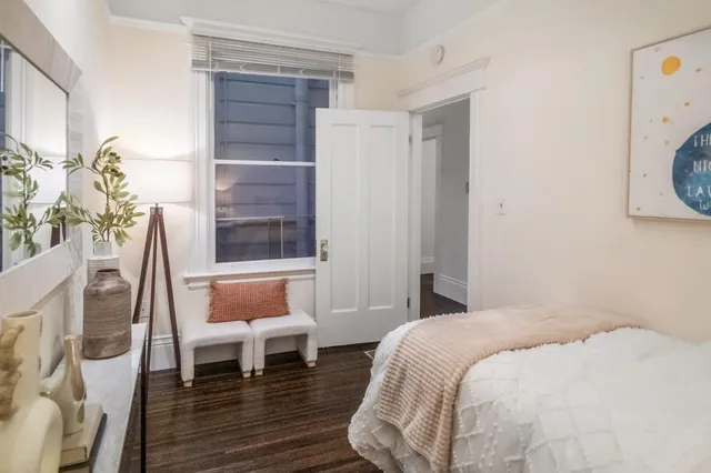 a bedroom with a bed and a chair