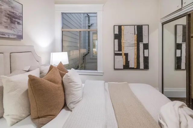 a bedroom with a bed and a mirror