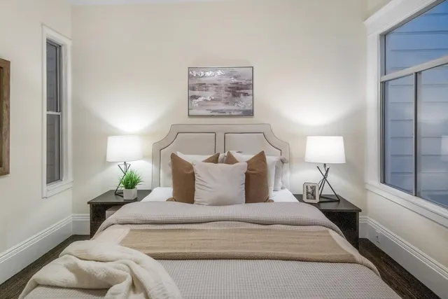 a bedroom with a bed and a lamp