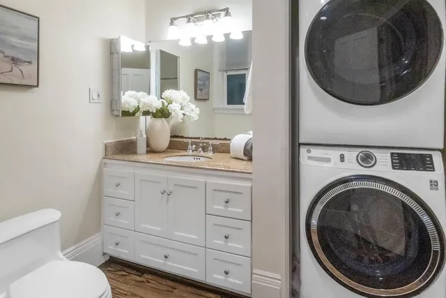 a bathroom with a toilet sink and mirror