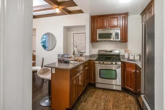a kitchen with stainless steel appliances granite countertop a stove and a sink