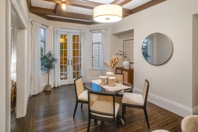 a dining room with furniture and wooden floor