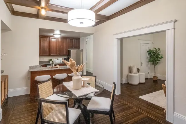 a view of a dining room with furniture wooden floor and chandelier