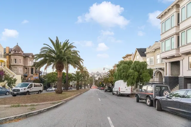 a couple of cars parked in front of a building