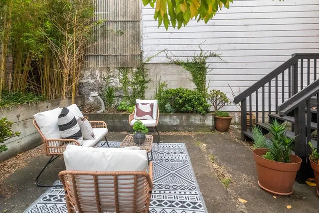 a view of a patio with table and chairs and potted plants