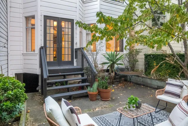 a view of a house with backyard sitting area and garden