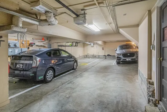 a view of parking garage with cars parked