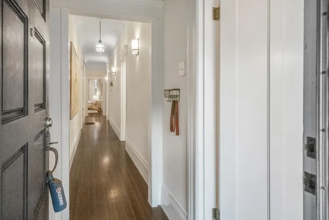a view of a hallway with a wooden floor