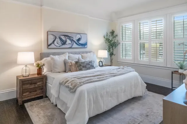 a bedroom with a bed and a night stand