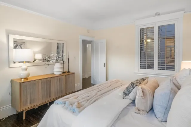 a bedroom with a bed and window