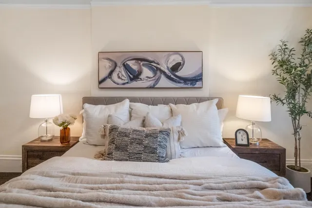 a large white bed in a white room
