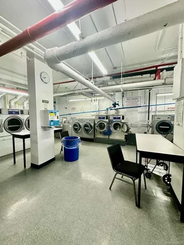 a utility room with lots of chairs and a table