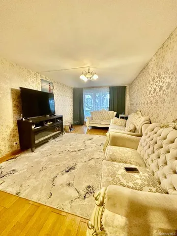 a living room with a flat screen tv and a couch