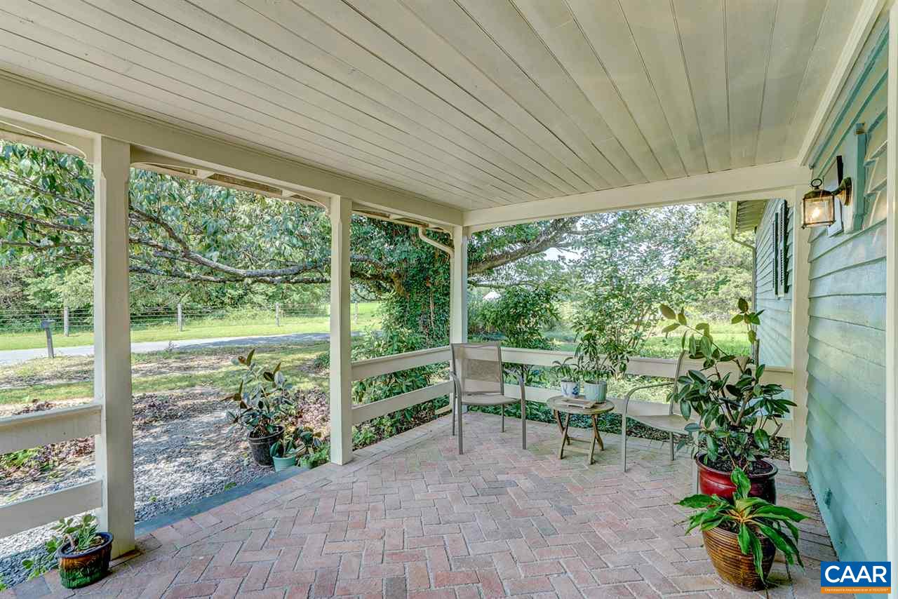2262 Hamilton Road Louisa, VA 23093 - Photo 31 of 49 a porch with chairs and potted plants