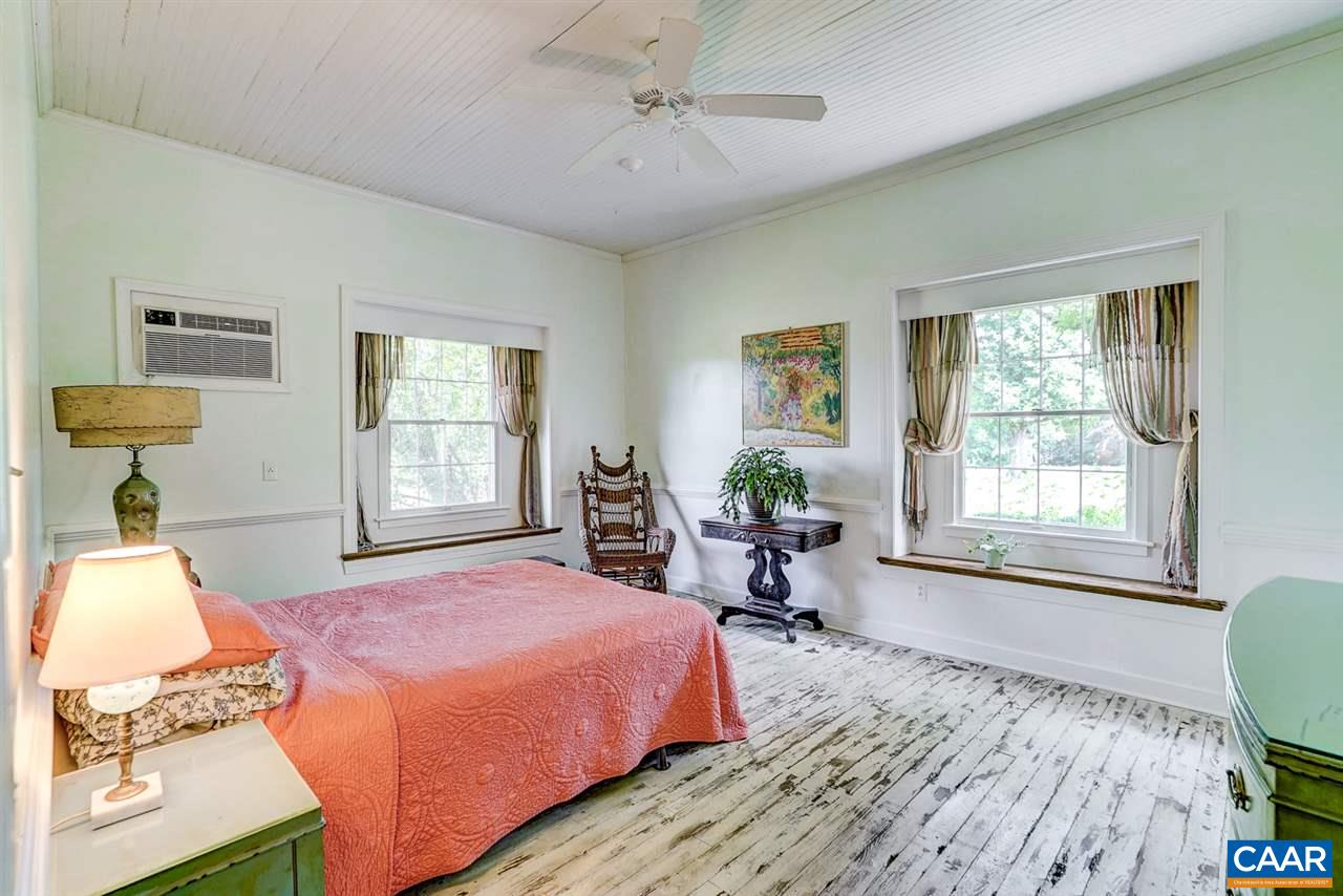 2262 Hamilton Road Louisa, VA 23093 - Photo 5 of 49 a bedroom with a bed a table and chair