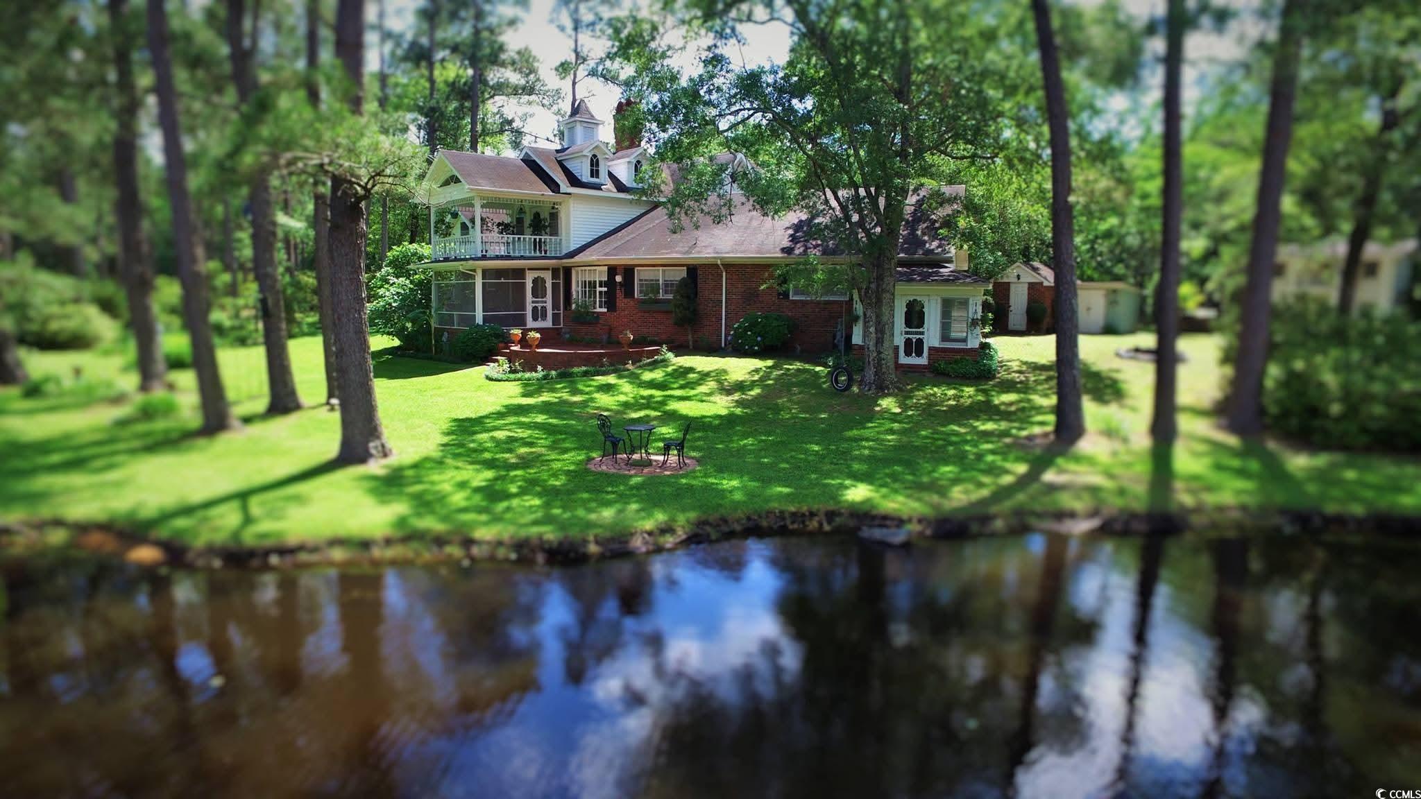 2840 Pennyroyal Road Georgetown, SC 29440 - Photo 2 of 36 Rear view of property featuring a water view, brick siding, a yard, and a balcony