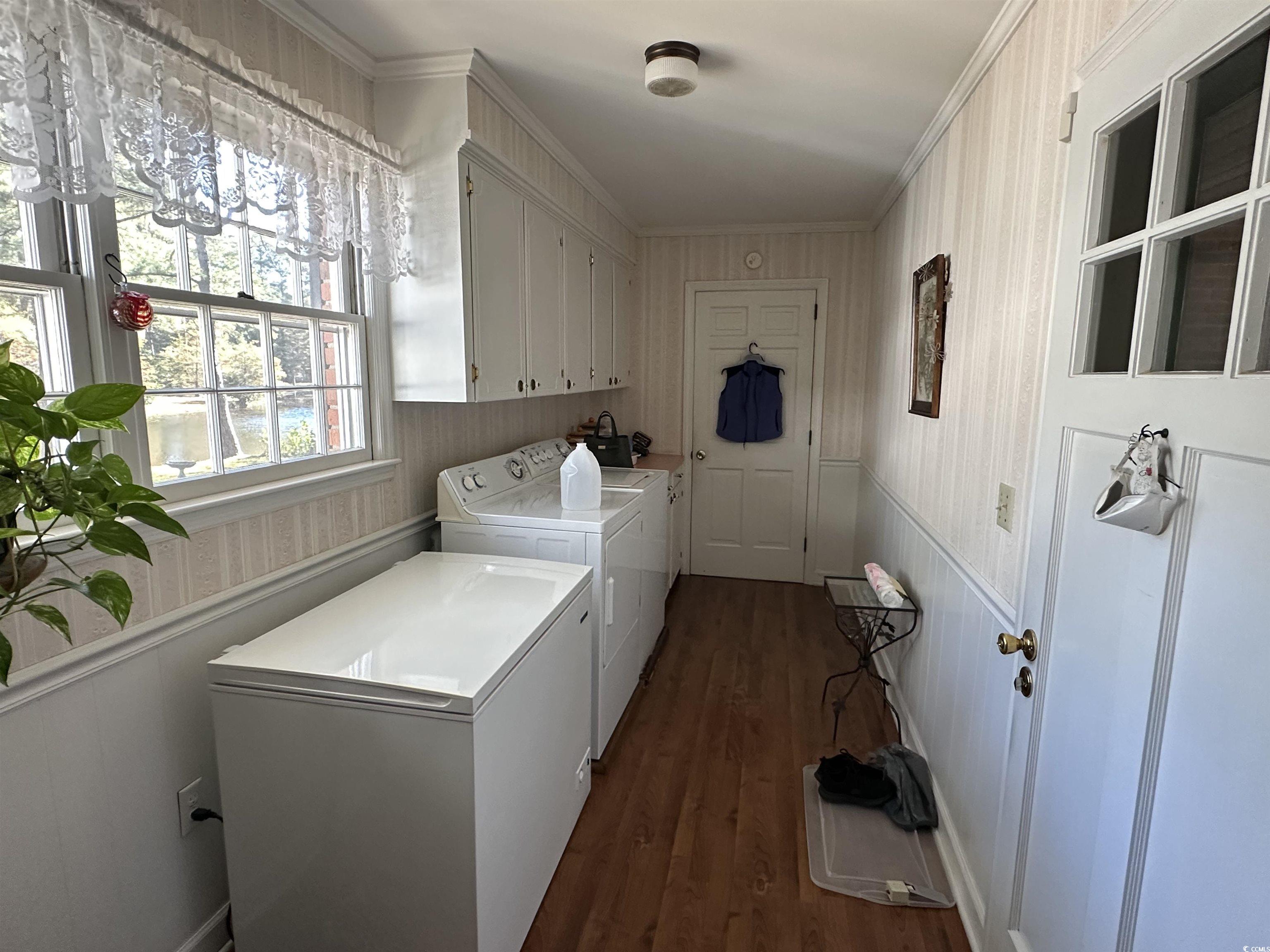 2840 Pennyroyal Road Georgetown, SC 29440 - Photo 29 of 36 Laundry area featuring cabinet space, dark wood finished floors, independent washer and dryer, a wainscoted wall, and ornamental molding