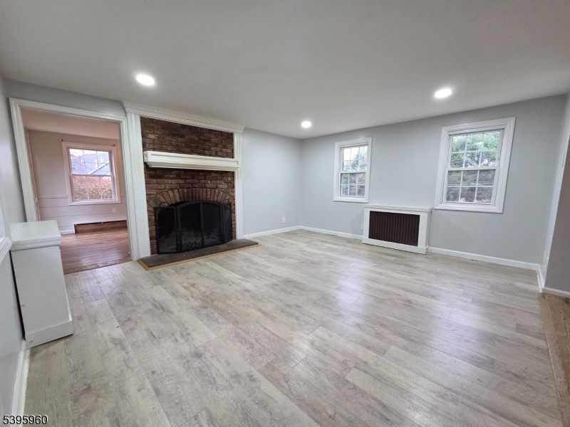 97 Fairmount Road West Califon, NJ 07830 - Photo 17 of 41 an empty room with windows fireplace and a sink