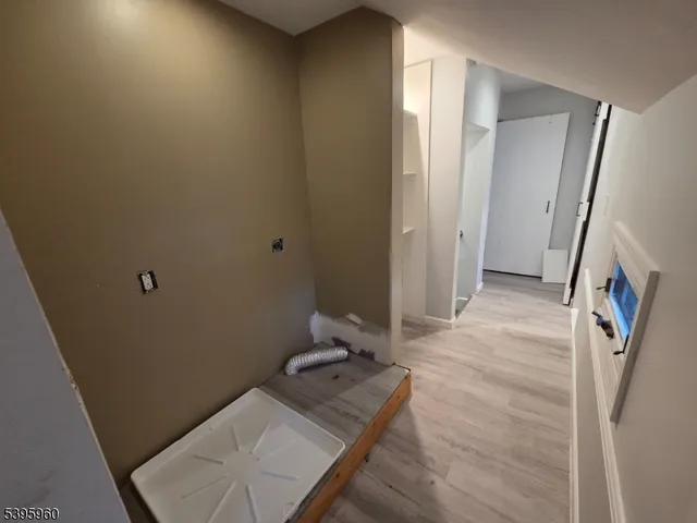 view of a hallway with wooden floor and a living room