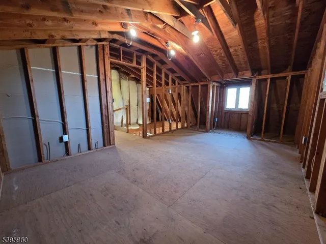 a view of empty room with wooden walls