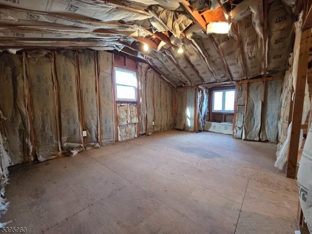 a view of empty room with wooden walls