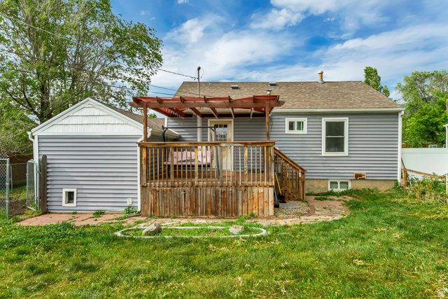 65 West 700 North Bountiful, UT 84010 - Photo 5 of 29 Rear exterior featuring a wooden deck with a pergola, gray siding, a pitched roof, and a fenced perimeter