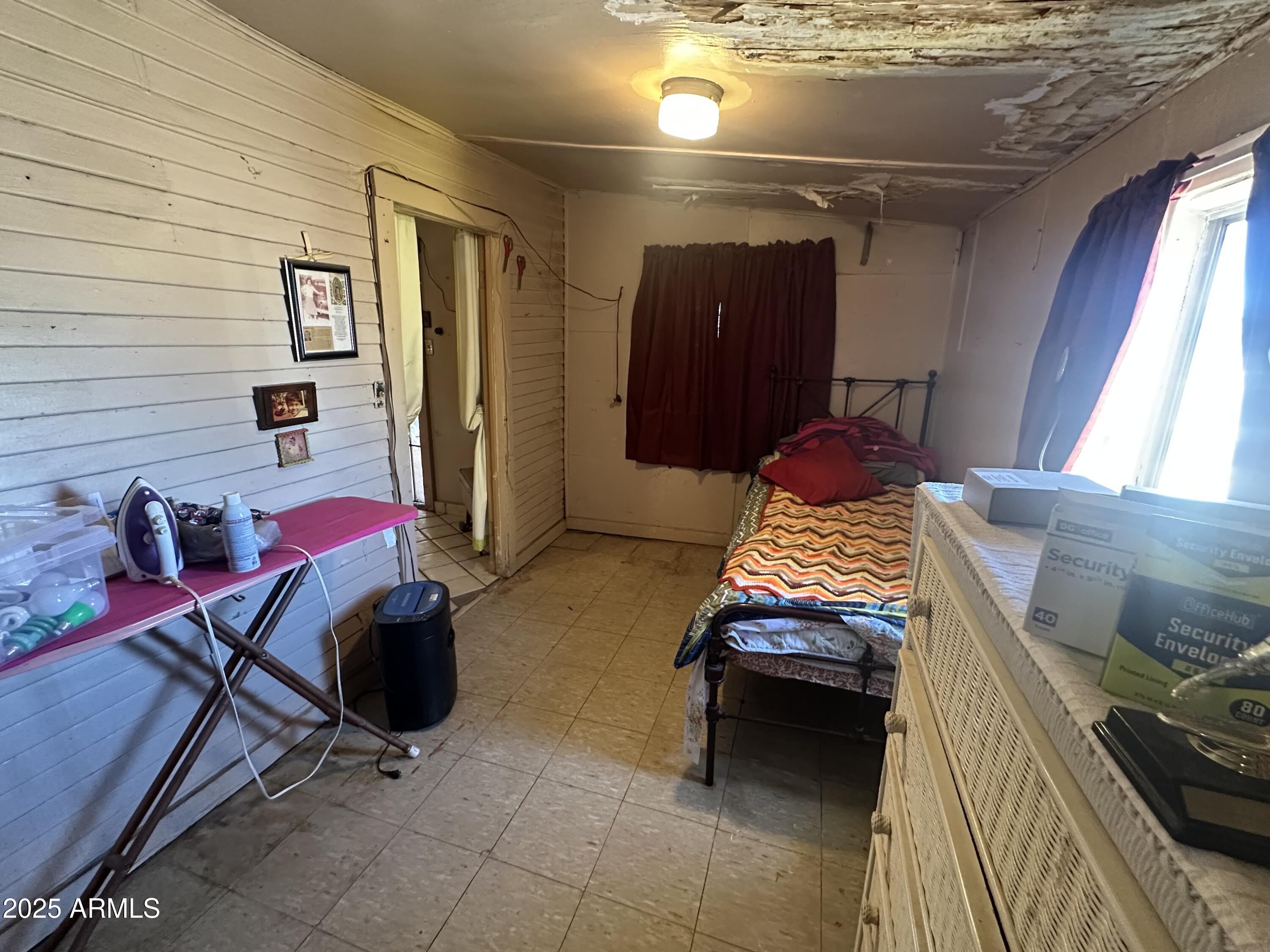 505 North D Street Eloy, AZ 85131 - Photo 12 of 25 a bedroom with a bed and a chandelier