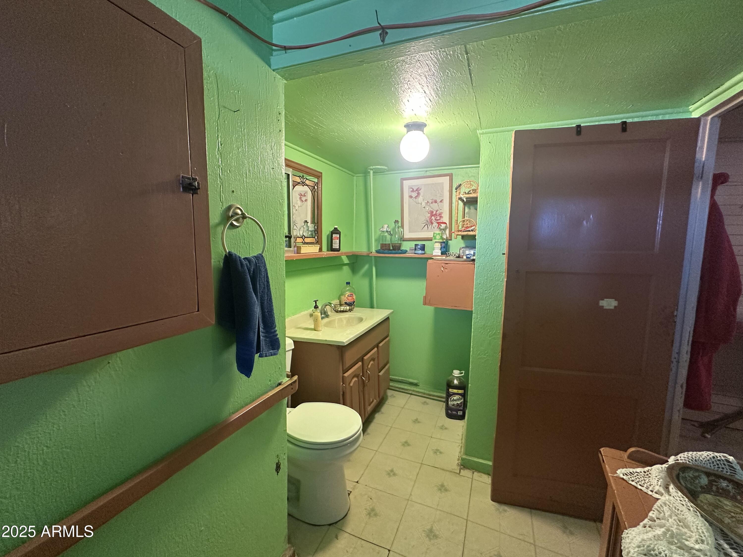 505 North D Street Eloy, AZ 85131 - Photo 13 of 25 a bathroom with sink toilet and green walls