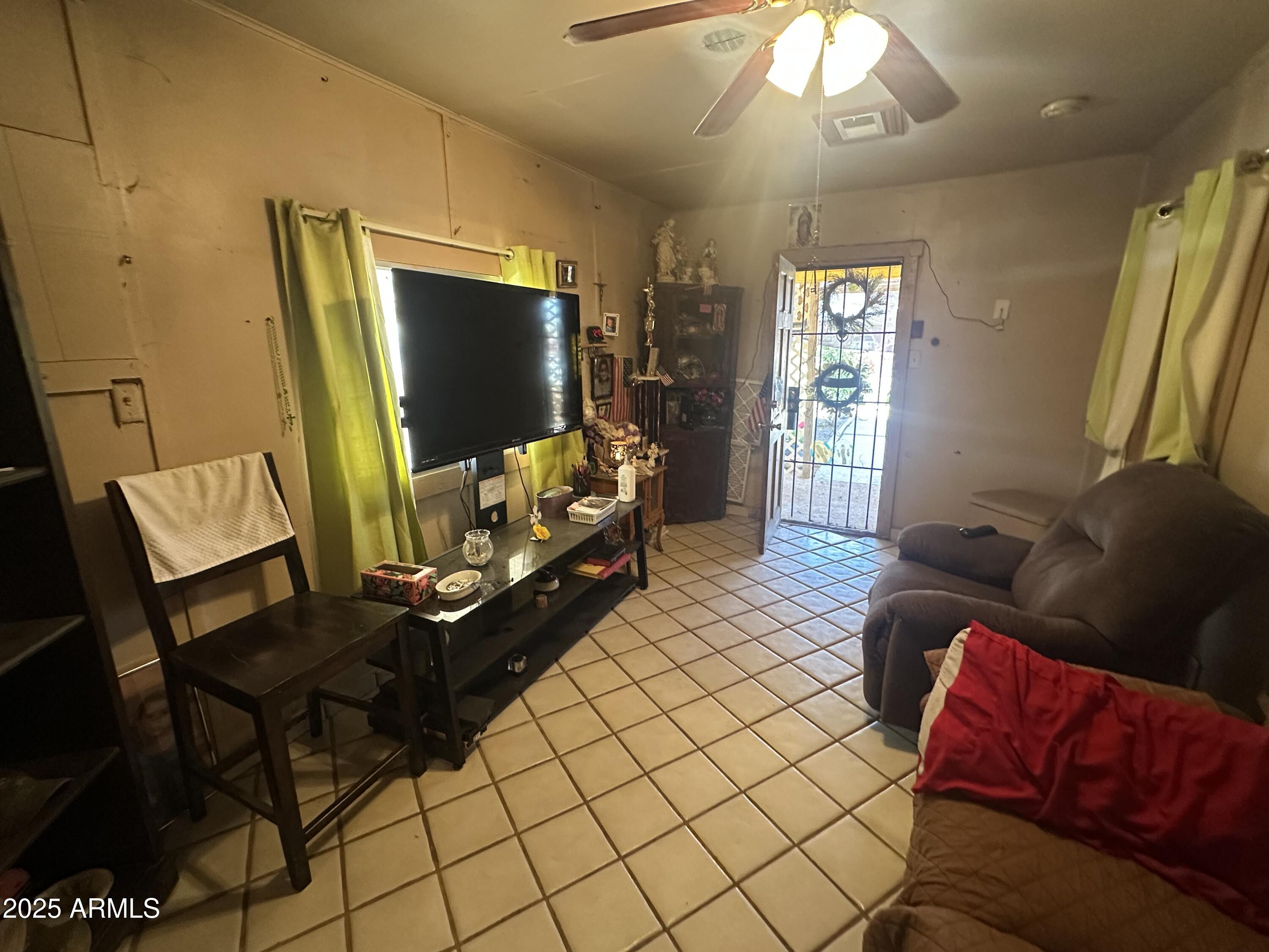 505 North D Street Eloy, AZ 85131 - Photo 7 of 25 a living room with furniture and a flat screen tv