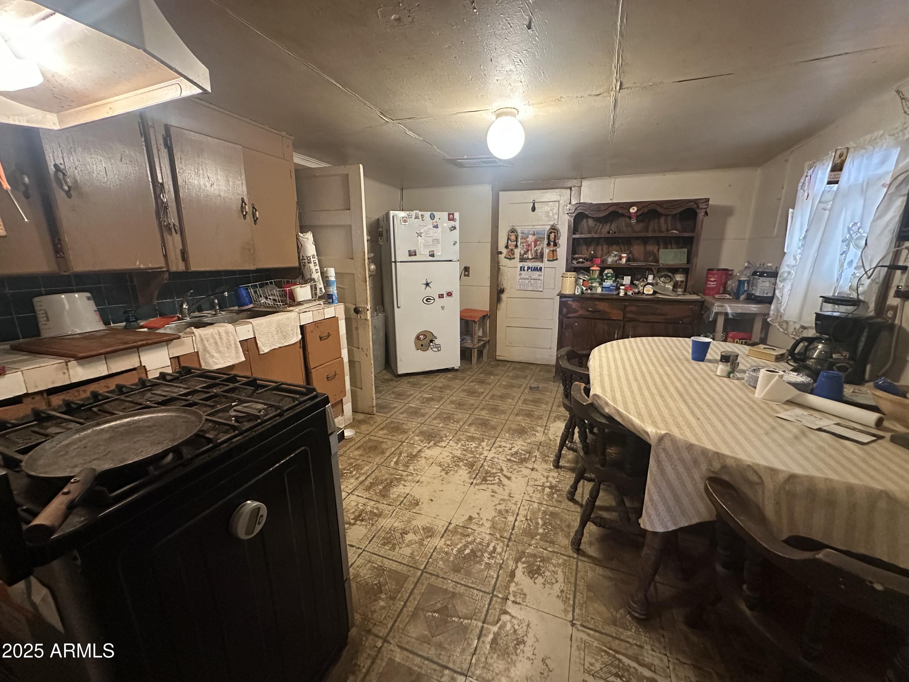 505 North D Street Eloy, AZ 85131 - Photo 8 of 25 a kitchen with stainless steel appliances granite countertop a stove refrigerator and a stove