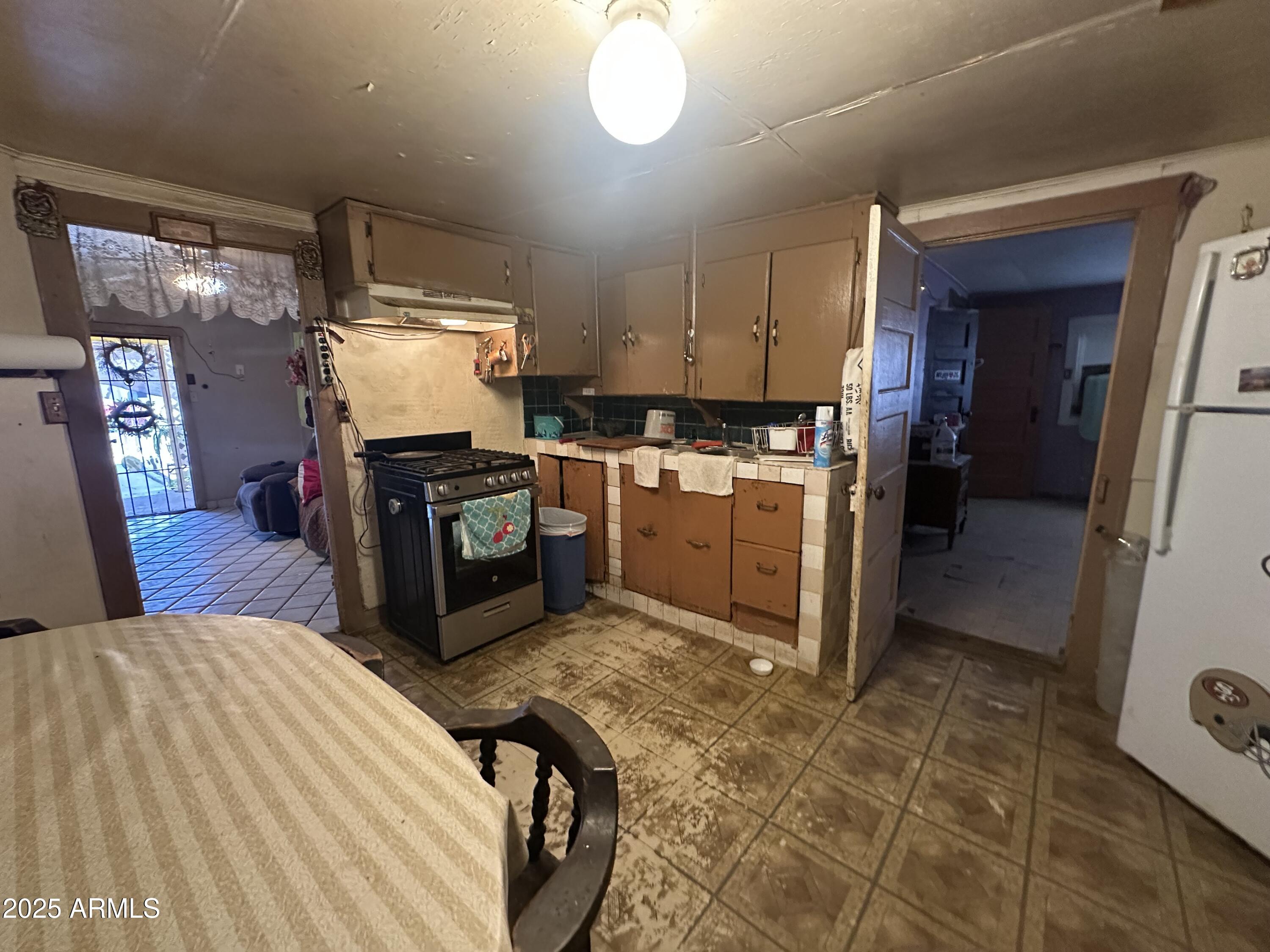 505 North D Street Eloy, AZ 85131 - Photo 9 of 25 a kitchen with stainless steel appliances granite countertop a sink a stove and a refrigerator