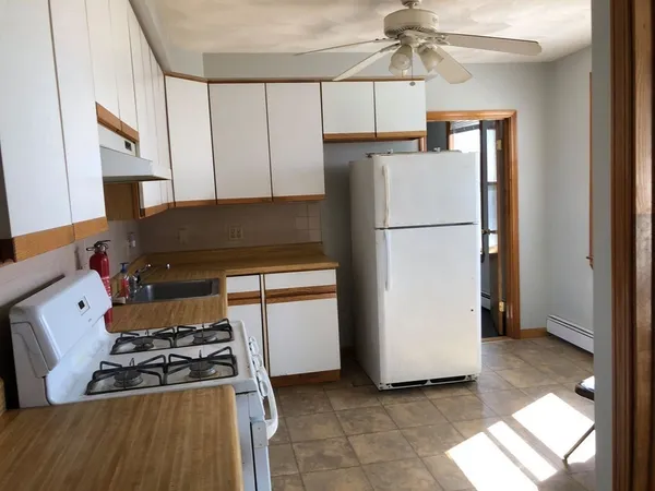 a kitchen with a refrigerator and a stove