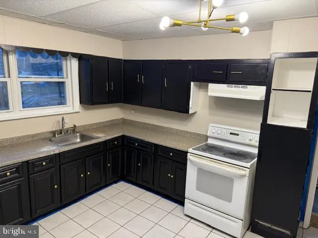 a kitchen with a cabinets and white appliances
