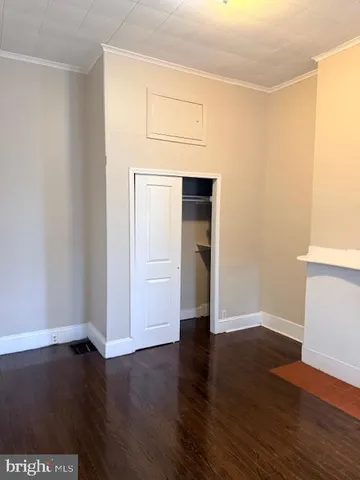 an empty room with wooden floor