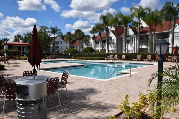 a view of a swimming pool with sitting area