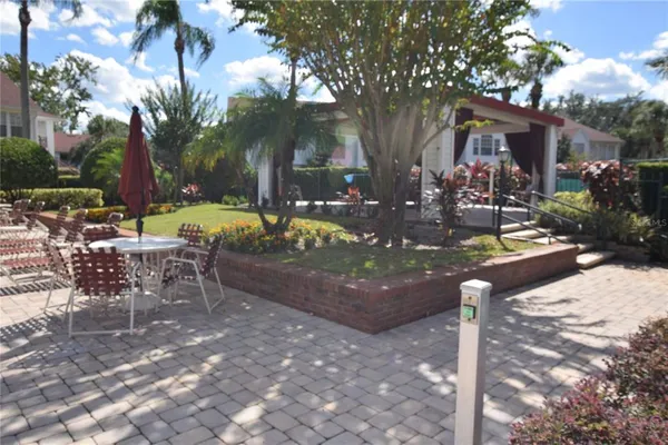 a view of a patio with table and chairs and potted plants