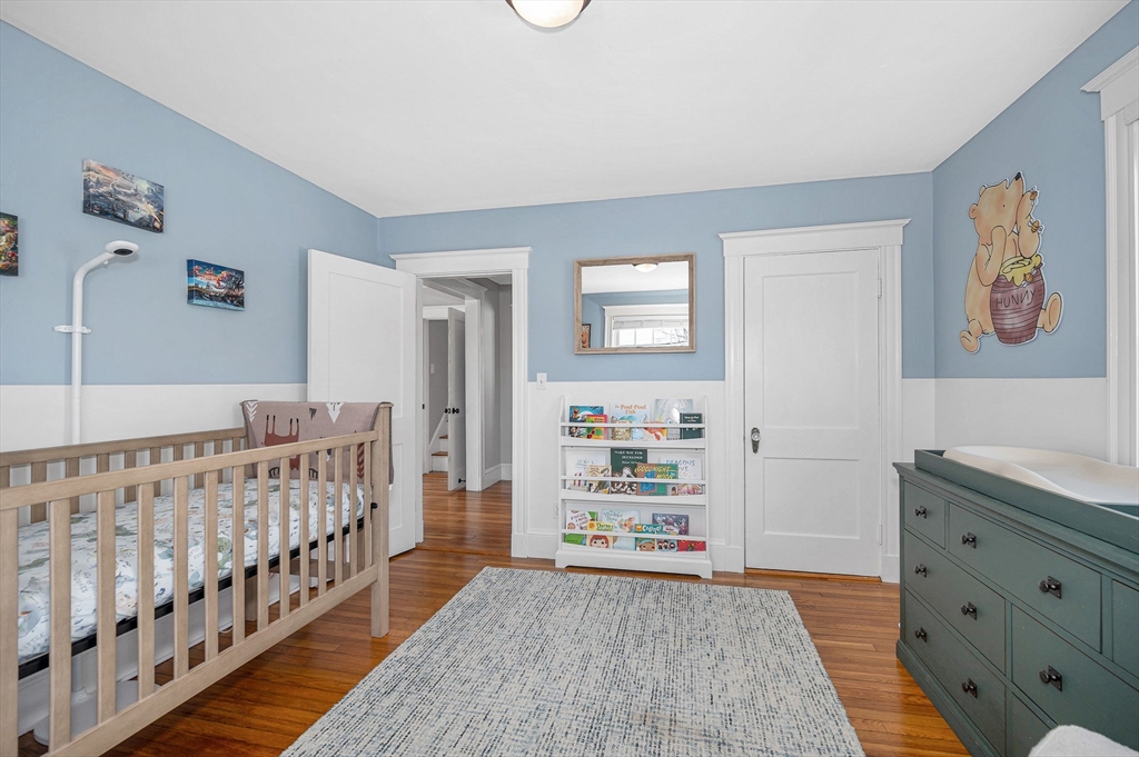 430 West Street Reading, MA 01867 - Photo 13 of 35 a bedroom with furniture and baby crib