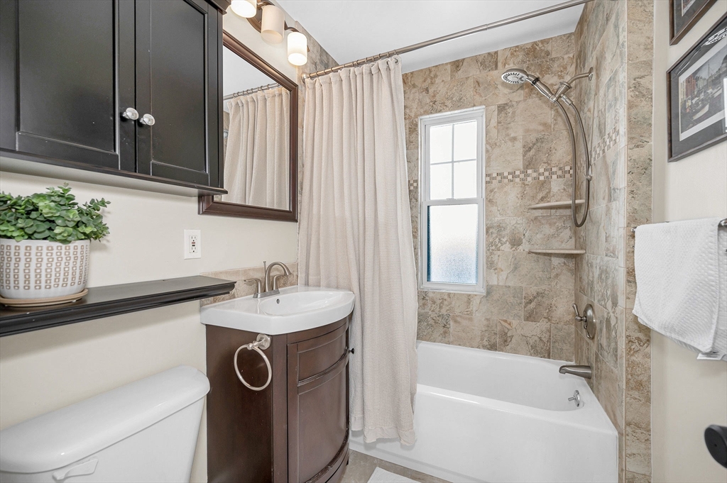430 West Street Reading, MA 01867 - Photo 14 of 35 a bathroom with a sink a mirror and a bathtub